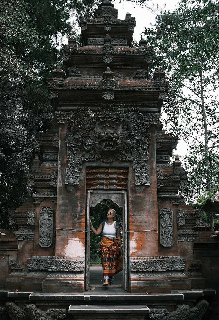 Lisa steht in einem Tempel-Tor auf Bali